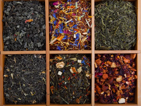 Assortment of dry tea in wooden box — Stock Photo, Image