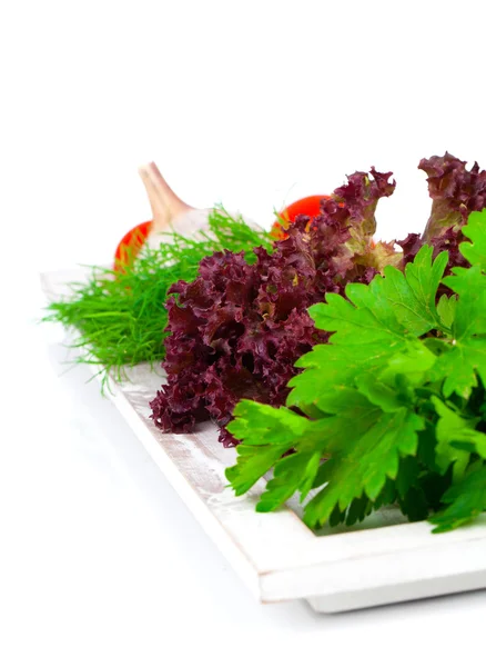 Green herbs in braided basket isolated on white background — Stock Photo, Image