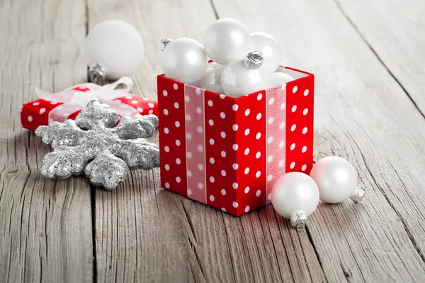 Red gift box with Christmas decoration on wood background — Stock Photo, Image