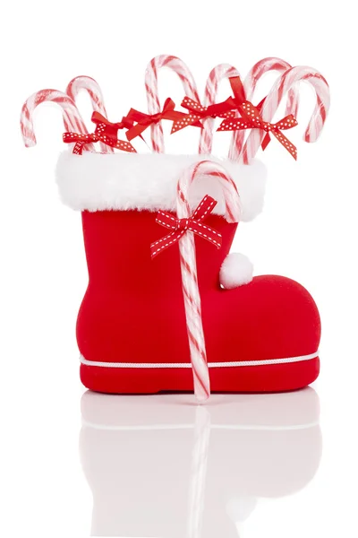 Santa's boot with candy canes on white background — Stock Photo, Image