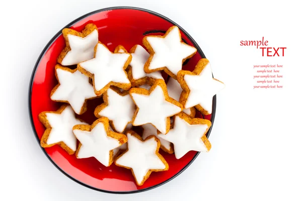 Christmas cinnamon star cookies on red plate — Stock Photo, Image