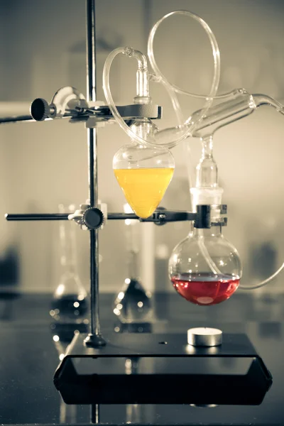 Glass laboratory apparatus with liquid samples — Stock Photo, Image
