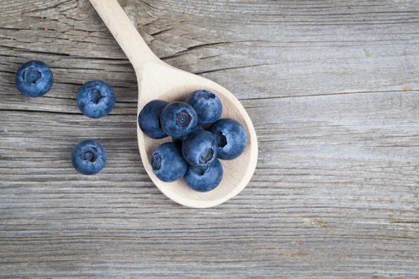 Blueberries on a wooden spoon — Stock Photo, Image