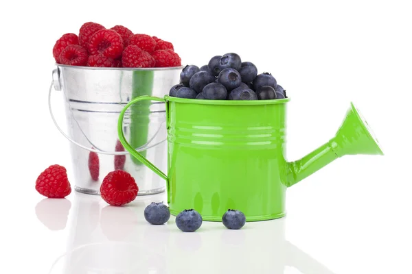 Fresh Blueberries in watering can, raspberries on white backgrou — Stock Photo, Image