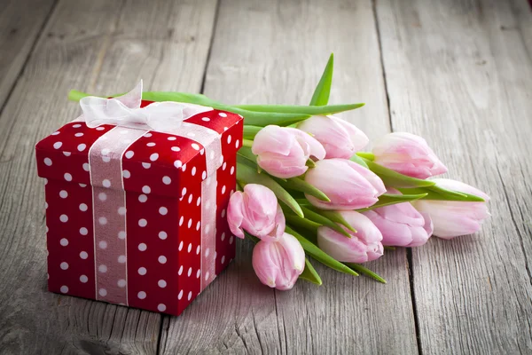 Hermosos tulipanes con caja de regalo de lunares rojos. feliz día de las madres , Imagen de archivo