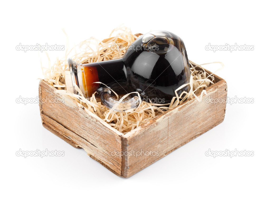 Bottles of wine or herbal syrup, in wooden box, over white backg