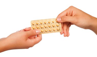 young woman holding birth control pills clipart