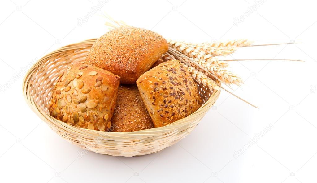 Baked bread bun in basket. isolated on white