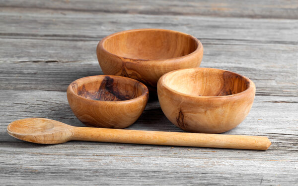 Wooden kitchen utensils on wooden background