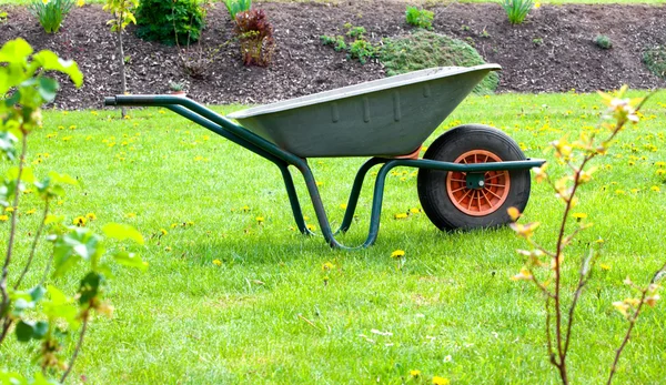 Garden-wheelbarrow on green grass — Stock Photo, Image