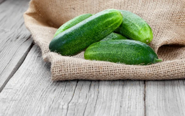 Cucumbers on the wooden background — Stock Photo, Image