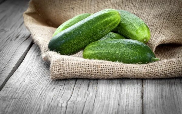 Cucumbers on the wooden background — Stock Photo, Image