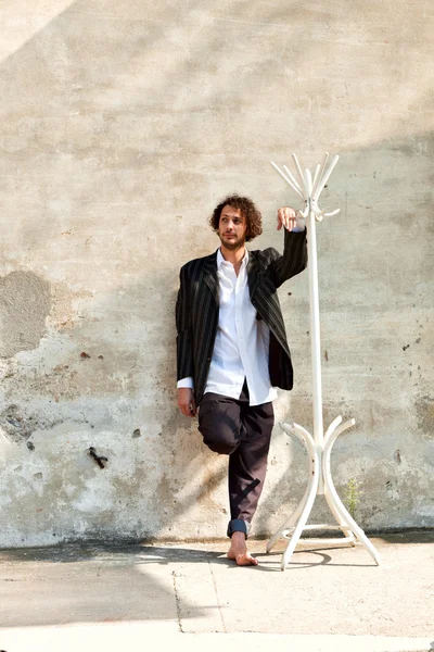 Boy and white coat rack — Stock Photo, Image