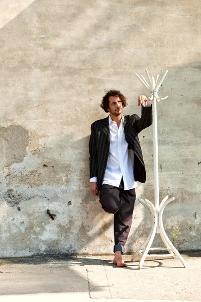 Boy and white coat rack — Stock Photo, Image