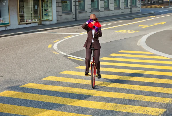 Business woman drink a coffee on the unicycle — Stock Photo, Image