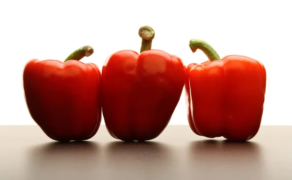 Three red peppers on white background — Stock Photo, Image