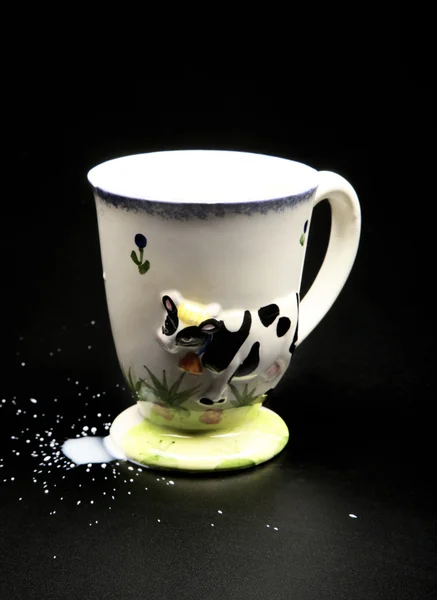 Cup for milk isolated on black — Stock Photo, Image