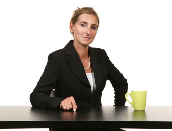Businesswoman sitting on desk