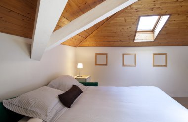 Comfortable bedroom in loft clipart
