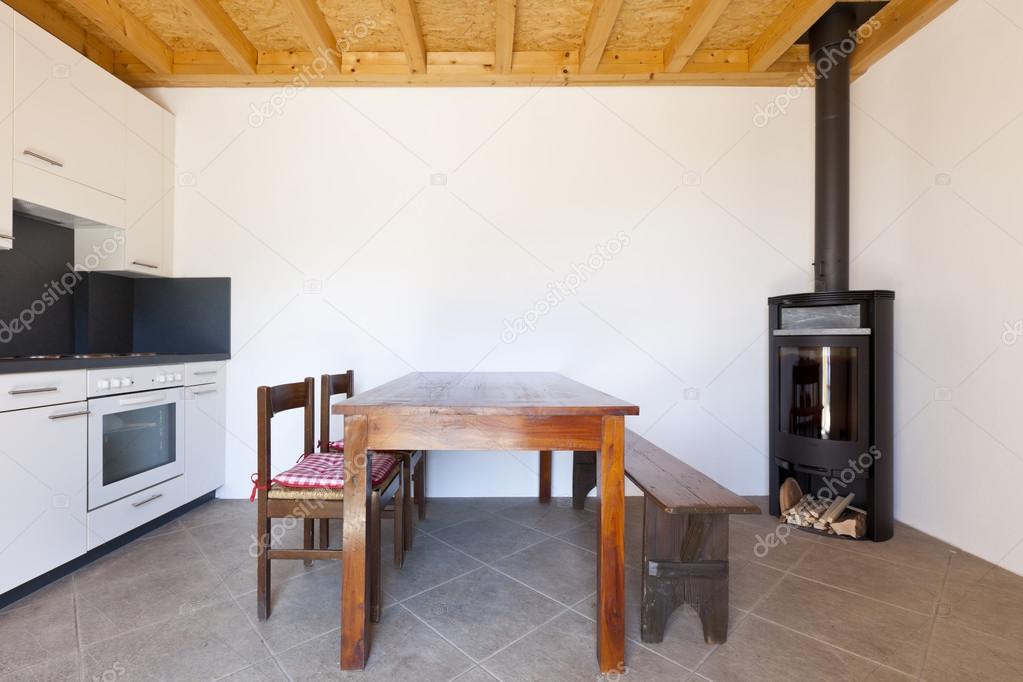 Room with table and wood stove