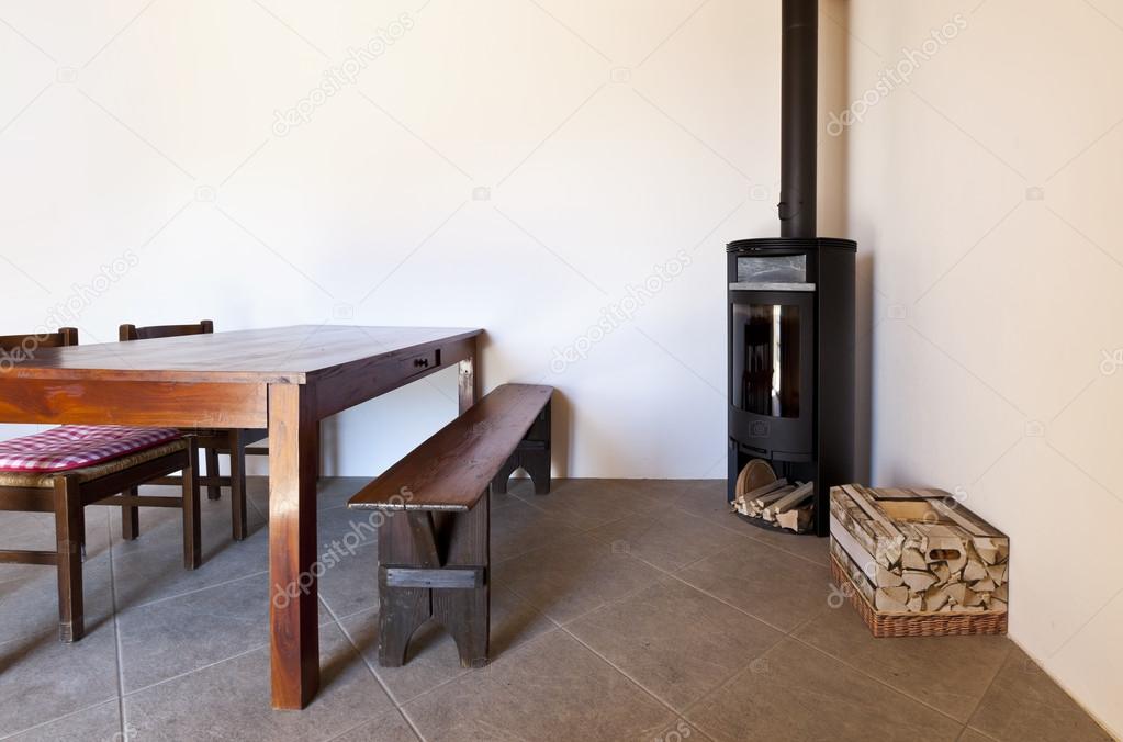Room with table and wood stove