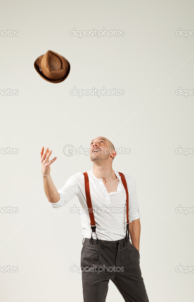 Man throws hat in air