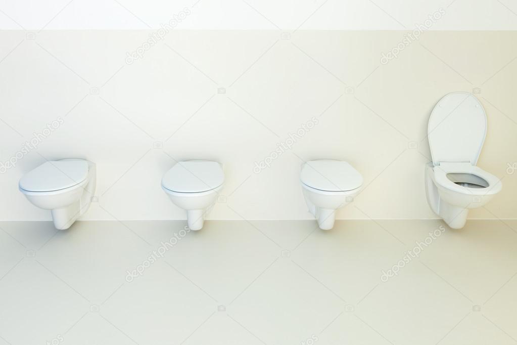 Public bathroom, toilets in a row