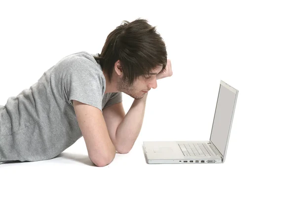 Boy lying with laptop — Stock Photo, Image