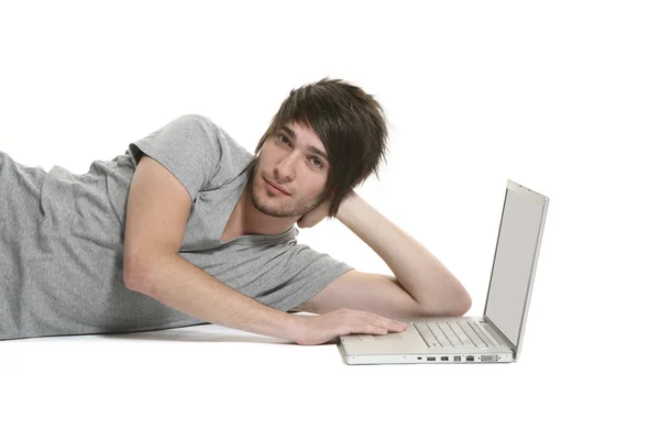 Boy lying with laptop — Stock Photo, Image