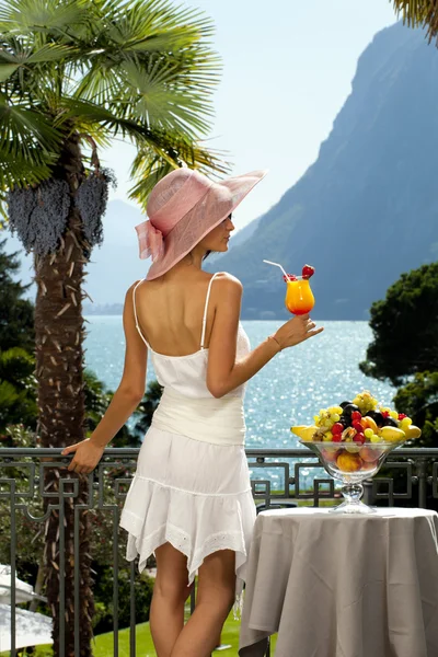 Vacker kvinna med cocktail på terrassen — Stockfoto