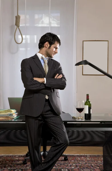 Businessman with wine and gallows — Stock Photo, Image