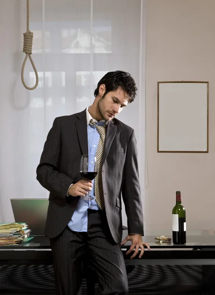 Businessman with wine and gallows — Stock Photo, Image