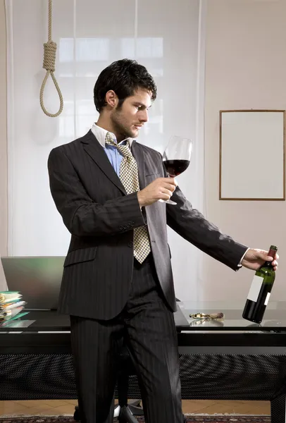 Businessman with wine and gallows — Stock Photo, Image