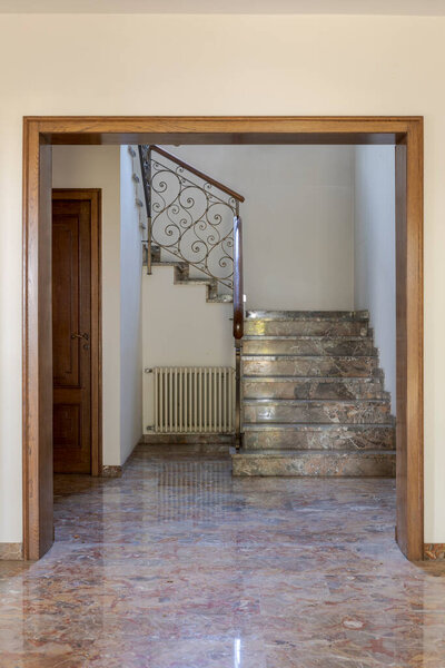 Front view marble staircase, iron railing. Interior of empty old villa to be renovated. Nobody inside
