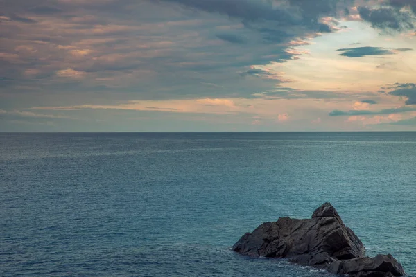 Calm sea with cloudy sky at sunset. Panorama of the Mediterranean sea in Liguria. Nobody inside