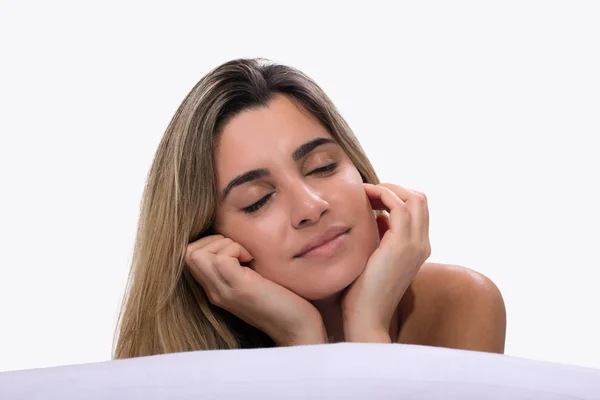 Genç kadın yatakta dinleniyor.