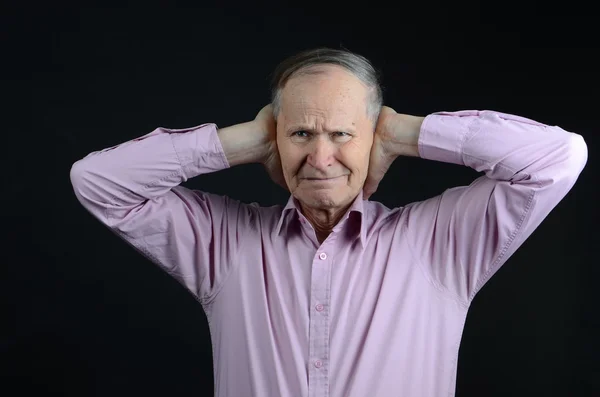 Senior closed his ears because of noice — Stock Photo, Image