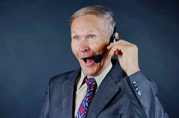 Smiling Businessman with headphones on black background — Stock Photo, Image