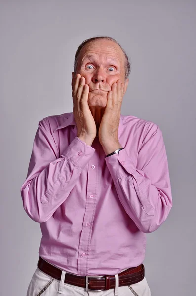 Shocked Senior man with hands on cheeks — Stock Photo, Image