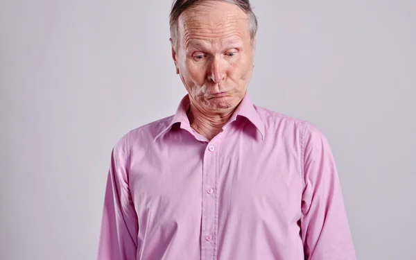 Funny face of mature man on grey background — Stock Photo, Image