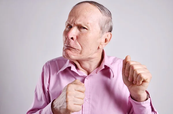 Angry mature man on grey background — Stock Photo, Image