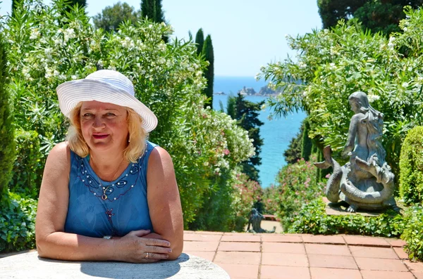 Lachende vrouw in witte hoed, natuur achtergrond. reis- en vakantie. vrijheid concept — Stockfoto