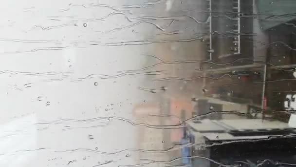 Drops of rain run down the glass of the window — Stock Video