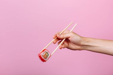 Öğretim: yemek çubuklarıyla nasıl yenir. Pembe arka planda izole edilmiş. Adım 5.