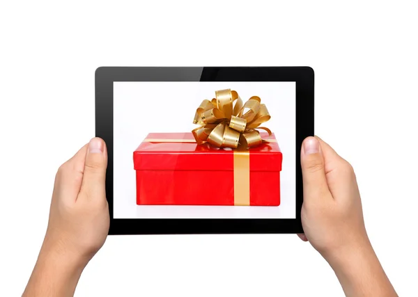 Men hands hold a tablet touch computer gadget with a gift — Stock Photo, Image