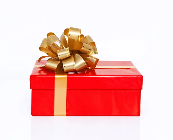 Isolated red gift box with a gold bow on a holiday — Stock Photo, Image