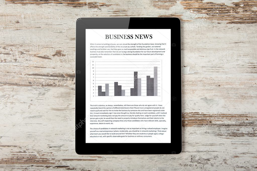 Tablet computer with business news on a screen