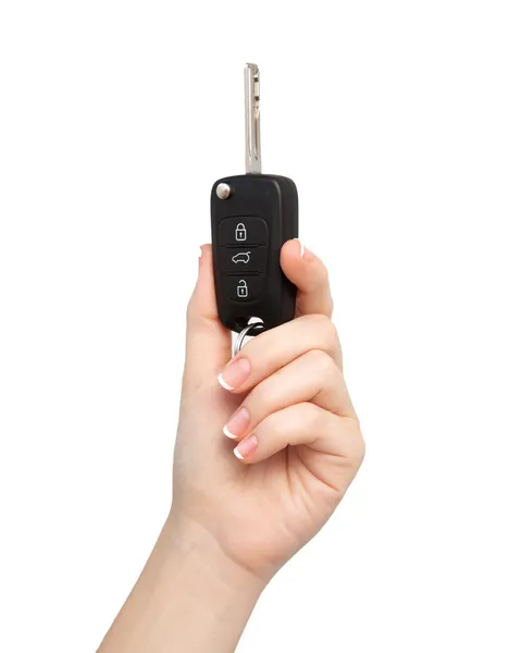 Mano de mujer sobre fondo aislado sosteniendo la llave del coche —  Fotos de Stock