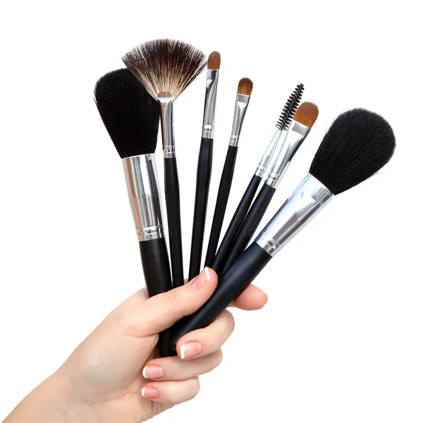 Isolated female hand with brushs for makeup — Stock Photo, Image