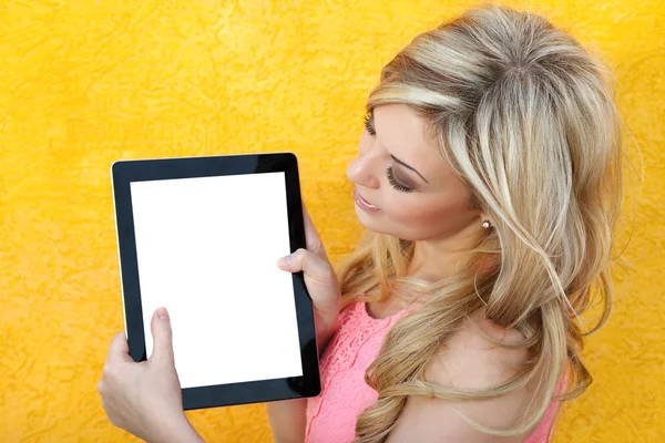 Beautiful girl holding the tablet and looking at the screen — Stock Photo, Image